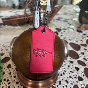 Coach triceratops hangtag